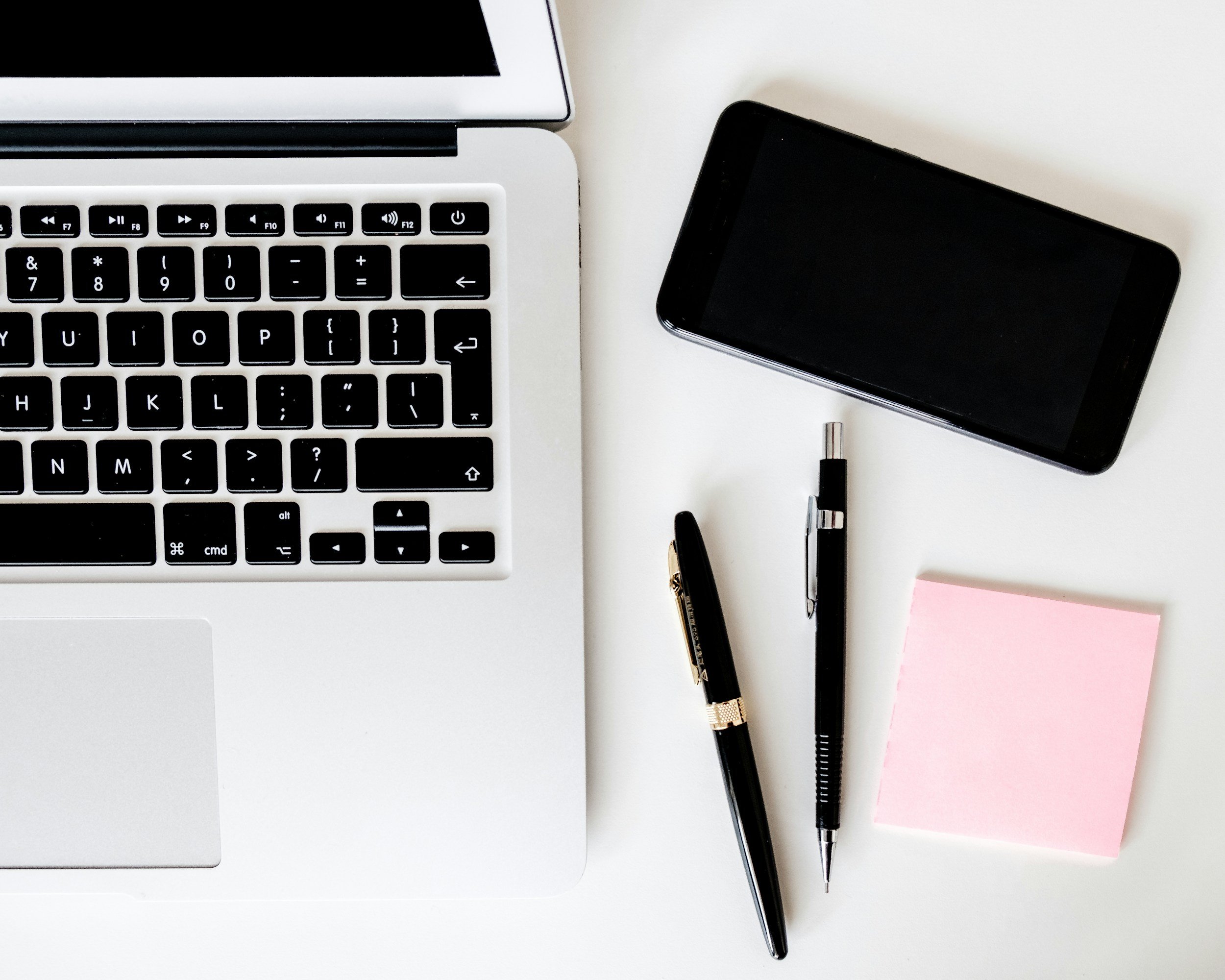 laptop pen and sticky post it notes